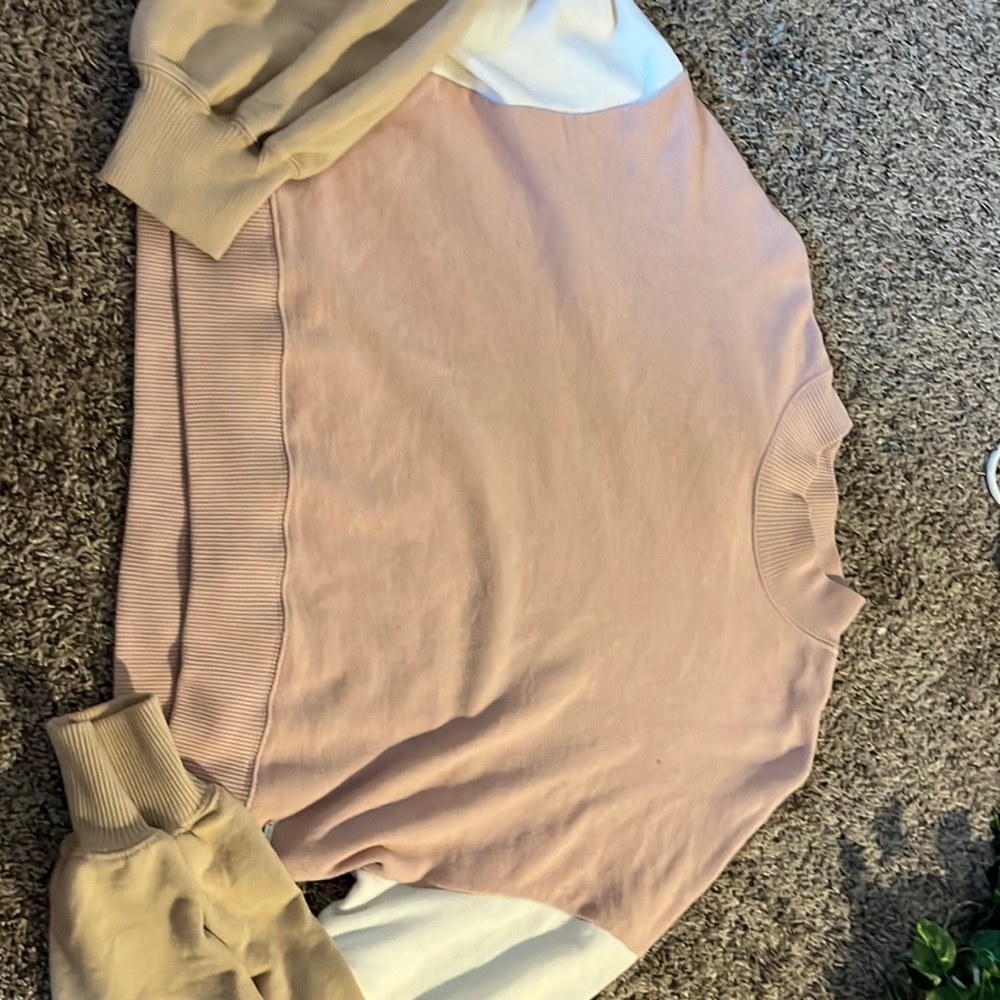 This is a really cute sweater. It was worn a couple of times and has a stain.